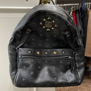 MCM Munchen Black backpack with zipper side purse included.